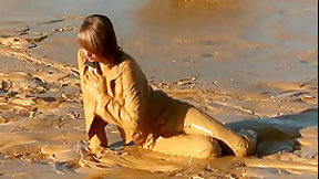 mud video: Brunette getting muddy in jeans