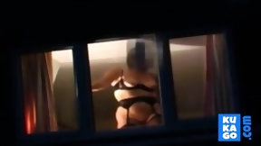 window video: Voyeur watching neighbour at window.