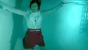 underwater video: Fully clothed babe underwater