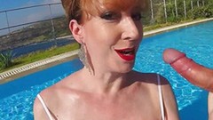 redhead video: British Mature Red XXX sucking cock in a pool