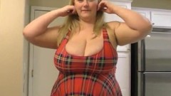 bbw video: Huge tits blonde milf in a short tartan skirt