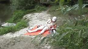 sunbathing video: Wild beach. Random passerby guy peeps on sunbathing topless beautiful Milf on the river bank Outdoors. Outside. Naked in