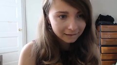 laughing video: Cute brunette is hearing requests on her webcam and laughs