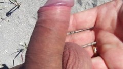 stroking video: Beach cock rub with extra hands
