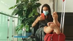 airport video: Girl hot soles feet legs in airport barcelona with mask