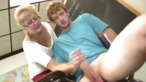 classroom video: Granny teacher tugs her students cock in the classroom